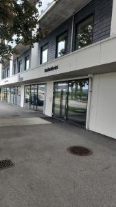 a large building with glass doors on the side of it at City housing in Stavanger