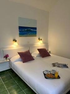 two beds in a room with a tray of food at Bungalow Retama in Tías +30 photos