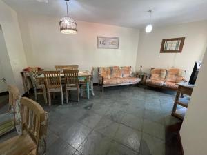 a living room with a table and chairs at Praia das Toninhas - Condomínio Summer Time APTO 33 in Ubatuba
