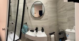 a bathroom with a sink and a mirror at Goldie's Retreat in Blackrod