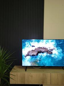 a flat screen tv sitting on top of a wooden cabinet at Bella Vista Durazzo in Golem