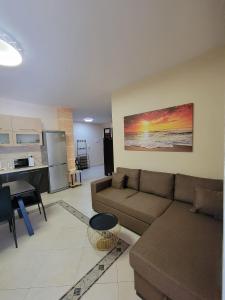 a living room with a couch and a kitchen at Bella Vista Durazzo in Golem