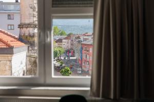 a window with a view of a city street at Apartment Center Korzo in Bihać