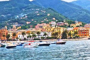 a group of boats in the water near a city at Tigullio Nest Rapallo in Rapallo