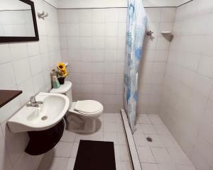 a bathroom with a sink and a toilet and a shower at Casa Cabieles Hostal in Yopal +16 photos