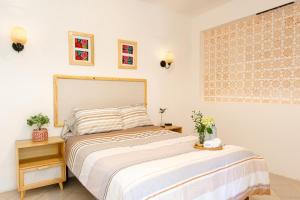 a bedroom with a large bed and two night stands at Casa Cataleya Refugio Bohemio y Romántico en Oaxaca in Oaxaca City +28 photos