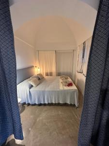 Postel nebo postele na pokoji v ubytování Dammuso Sataria