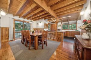 a dining room with a wooden table and chairs at Our Glenbogle in Medlow Bath