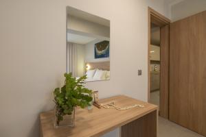 a room with a table with a potted plant on it at AM Suites Kefalonia in Argostoli +122 photos