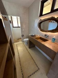 a bathroom with a sink and a mirror at Casa la Vista: New, luxury villa with infinity pool & ocean views in Mazunte +94 photos