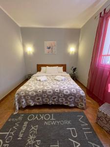 a bedroom with a bed and a red window at Apartments Villa-G Lustica in Tivat