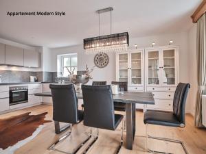 a kitchen with a dining room table and chairs at Villa Sunside Schluchsee - Appartements Modern Style & Superior in Schluchsee