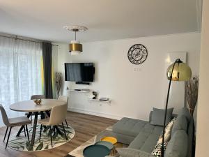 a living room with a couch and a table at Belle maison avec jardin ! in Bezannes-les-Reims +9 photos