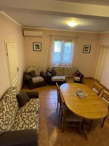 a living room with a table and a couch at Apartments Villa-G Lustica in Tivat