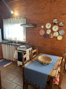 a kitchen with a table with a blue tablecloth on it at Casa Flor de Lis in Águas de São Pedro