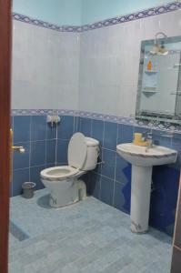 a bathroom with a toilet and a sink at Peaceful and cozy appartement, very good location in Sidi Slimane