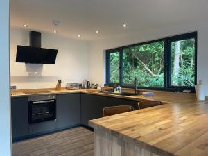 a kitchen with a counter top and a large window at Cherrybrae Cottage in Saint Fillans