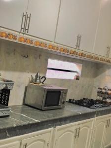 a microwave sitting on a counter in a kitchen at Peaceful and cozy appartement, very good location in Sidi Slimane