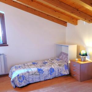 a bedroom with a bed and a wooden ceiling at Mountain Lake Endine- Iseo Milly's Home in Bianzano +37 photos