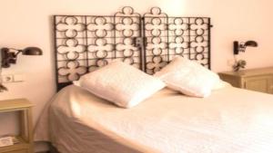 a bedroom with a bed with two pillows on it at New Villa Es Novells Illes Balears in Illes Balears