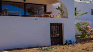 a white house with a door and a window at New Villa Es Novells Illes Balears in Illes Balears