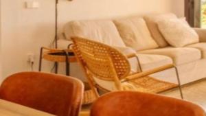 a living room with two chairs and a couch at New Villa Es Novells Illes Balears in Illes Balears