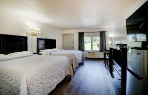 a hotel room with two beds and a television at Canaan Motel in Canaan