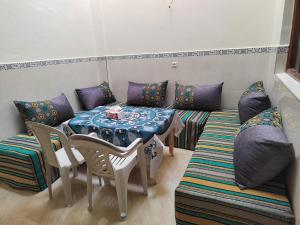 a living room with a table and a couch at Dar Aglou Appart 1 in Aglou