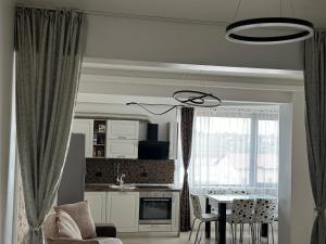 ナボダリにあるApartament Complex Zigzag Mamaia Nordのテーブルとキッチンのあるリビングルーム