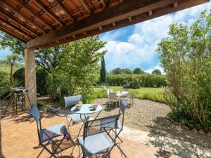 a patio with a table and chairs and a grill at Beautiful domaine with private pool and park in Cazouls-lès-Béziers