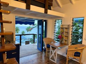a dining room with a view of the ocean at BougainVilla Savusavu in Savusavu