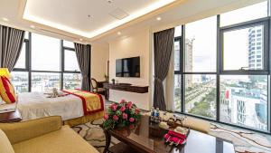 a hotel room with a bed and large windows at THE SHINE 2 HOTEL & APARTMENT in Ðông Khê
