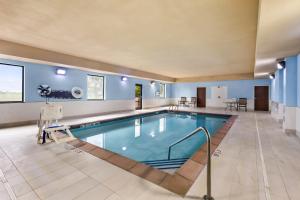 a swimming pool in a hotel room with a pool at Holiday Inn Express Hotel & Suites Van Wert by IHG in Van Wert