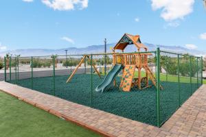 a playground with a slide in a park at Paradise Tiny #3 in Desert Hot Springs