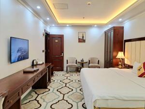 a hotel room with a bed and a desk at THE SHINE 2 HOTEL & APARTMENT in Ðông Khê