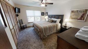 a bedroom with a bed and a ceiling fan at Whispering Pines - On the River - Great Views - Satellite - WiFi - Great Outdoor Deck! in Red River +21 photos