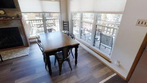 a dining room with a table and chairs and a balcony at Whispering Pines - On the River - Great Views - Satellite - WiFi - Great Outdoor Deck! in Red River