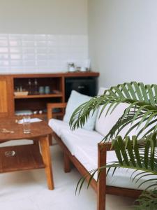 a living room with a couch and a table at Neptune Studios Luxury Villa with Pool Gym & Recovery in Kuta Lombok