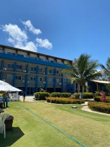 a blue building with a hose in front of it at Apart Hotel Marinas Tamandaré in Tamandaré