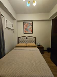 a bedroom with a large bed in a room at Verdon Parc 2 Bedroom Unit with Big Balcony in Davao City +13 photos