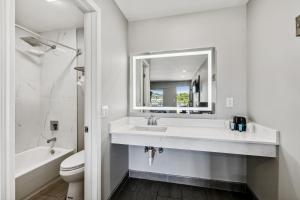 a bathroom with a sink and a toilet and a mirror at Knights Inn Antioch in Antioch