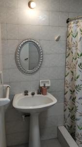 a bathroom with a sink and a mirror at Mono Microcentro Tucuman in San Miguel de Tucumán