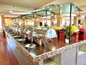 a kitchen with a counter with a bunch of food at Hotel El Jaguar in San Martín de las Pirámides