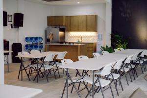 a group of tables and chairs in a kitchen at Pierre Hotsprings in Los Baños