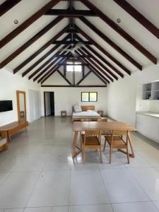 a large room with a table and a bed at Vila Del Mare Oceanfront Villas in Port Vila