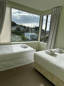 Rúm í herbergi á Elevated Views Little Kaiteriteri 3 bedrooms