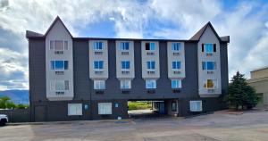 a large building with blue and white windows at Olympia Inn in Colorado Springs