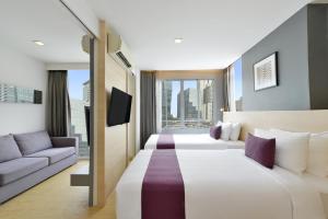 Postel nebo postele na pokoji v ubytování Arize Hotel Sukhumvit