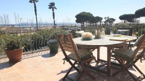 a table and chairs on a patio with a view of the ocean at Plage Miramar in La Londe-les-Maures +7 photos