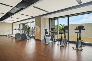 a gym with treadmills and elliptical machines at Valoisa by Kozystay - Fatmawati in Jakarta